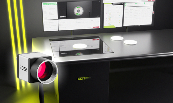 COMI Label Reader as a desktop scanner, with three yellow light strips on the left and an uEye camera in front
