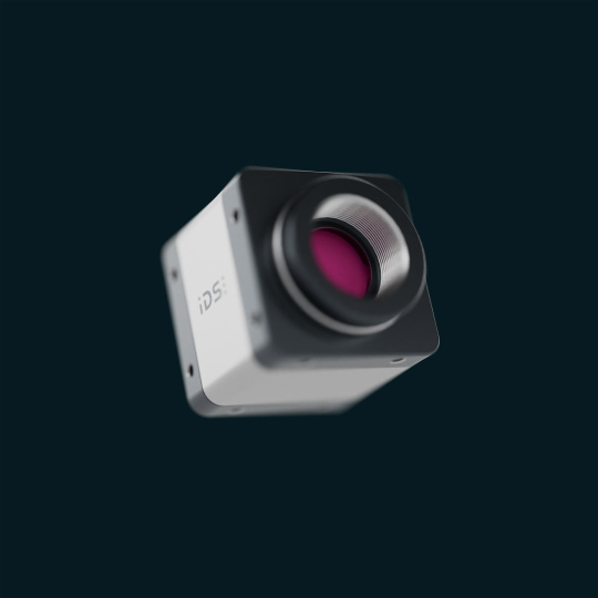 IDS industrial camera with lens mount against a dark background.