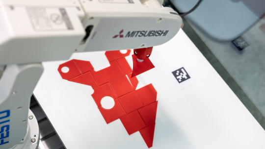 Robot places object at defined position.
