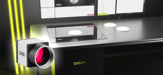 COMI Label Reader as a desktop scanner, with three yellow light strips on the left and an uEye camera in front