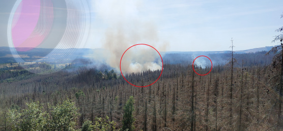 Forest fire marked in red, an IDS industrial camera is faded in the top left corner