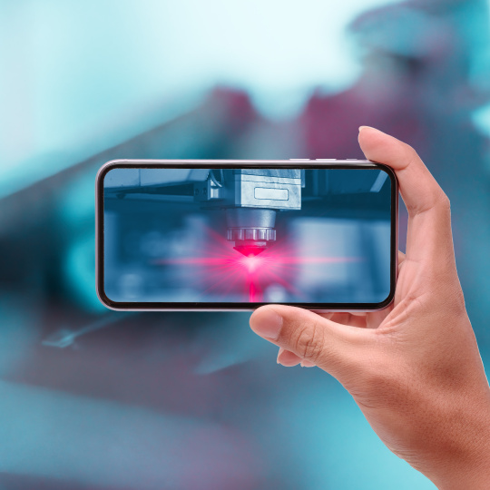 Hand raises mobile phone horizontally, red light illuminates on mobile phone