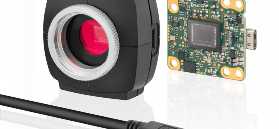 Picture of a uEye camera, left with housing, right without, cable in front