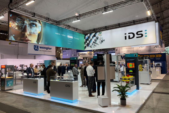 IDS booth at VISION featuring live demos for industrial machine vision.