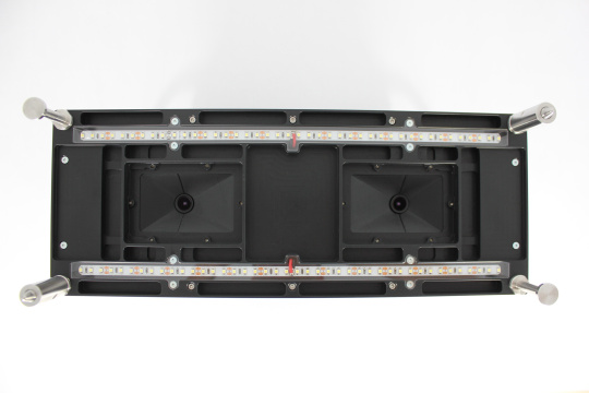 Bottom of a black module with LED strips, lenses and metal handles