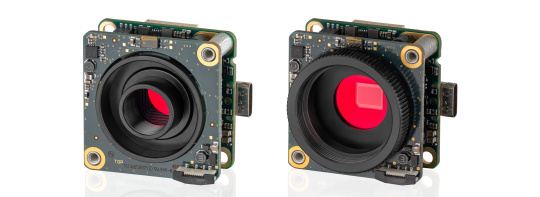 Two uEye LE AF cameras next to each other in front of a white background.
