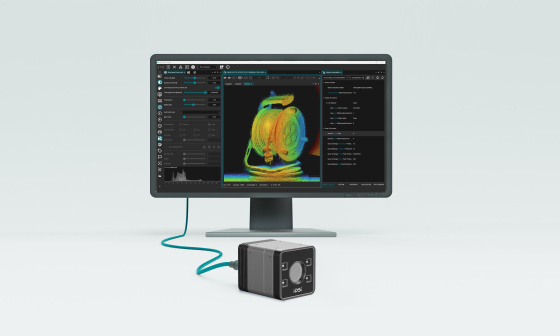 3D camera in front of a monitor displaying a coloured point cloud and a software interface