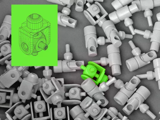 Various scattered white mechanical parts with one assembled green component highlighted, alongside a blueprint in the top left corner.