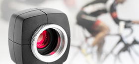 Industrial camera uEye in front of a blurred background with a cyclist