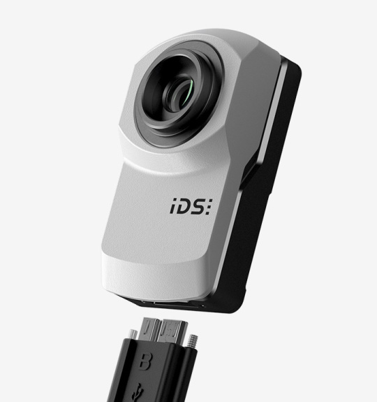IDS industrial camera uEye XC in front of a grey background.
