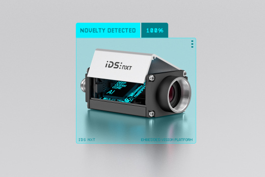IDS NXT with open housing, with ‘AI’ in neon lettering. Camera in a blue frame and the lettering ‘novelty detected 100%’