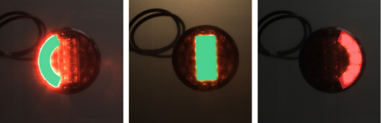 3 images of a multi-chamber vehicle lamp with one activated green or red light each