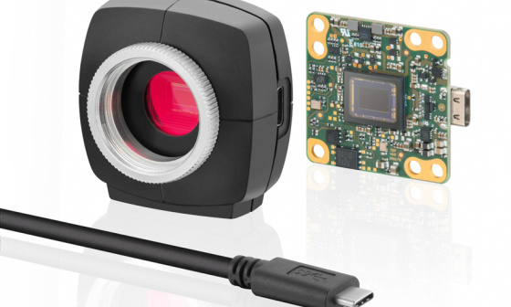 Picture of a uEye camera, left with housing, right without, cable in front