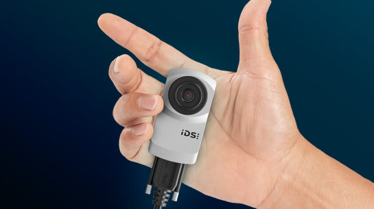 One hand holds an IDS camera firmly in place.