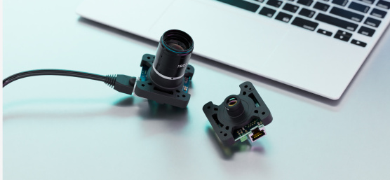 2 uEye SLE single-board cameras with different optics in front of laptop keyboard