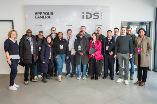 MIT REAP programme visitor group during their stay at IDS in front of a brand wall