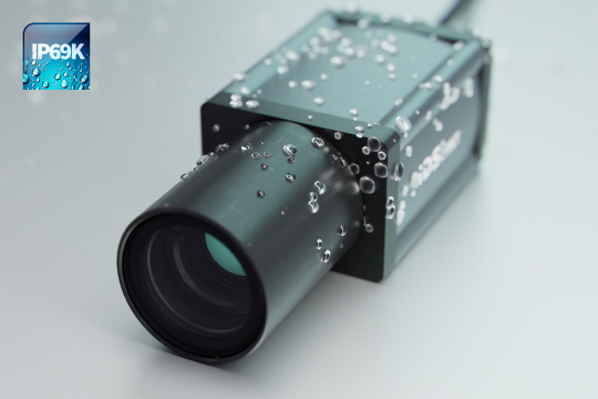IDS NXT AI camera with lens and water droplets on the housing and IP69K icon