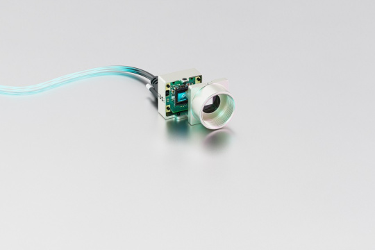 uEye XCP camera with cable in front of a grey background.