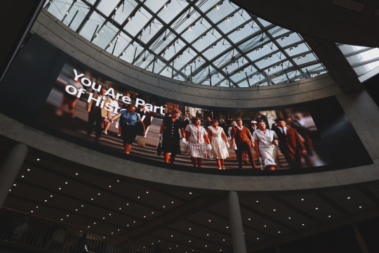 A giant projection of a historical scene beneath the glass dome at the Haus der Geschichte