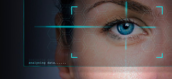 Human eye in the field of view of a camera with text "analysing data".