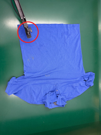 Blue T-shirt on green background, uEye XC camera on movable arm inspects from above