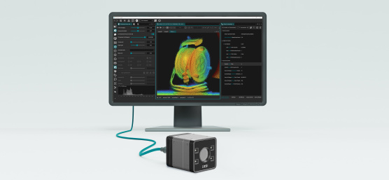 3D camera in front of a monitor displaying a coloured point cloud and a software interface