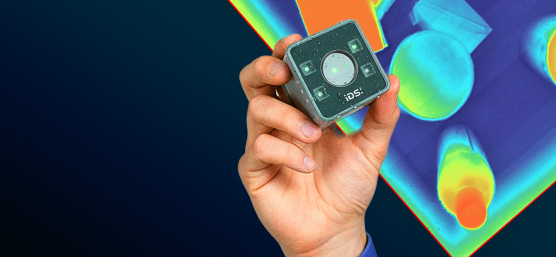 A hand on a blue background holding a Nion industrial camera