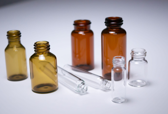 4 brown threaded vials and 4 transparent ampoules are placed next to each other