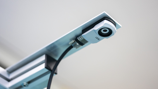 uEye XC camera positioned above the work surface.