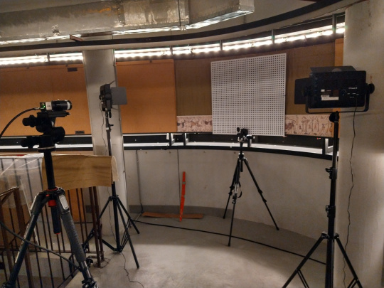 A calibration plate attached to the wall with lights and a uEye camera.