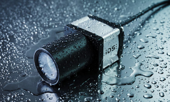 IDS industrial camera with lens on a wet surface